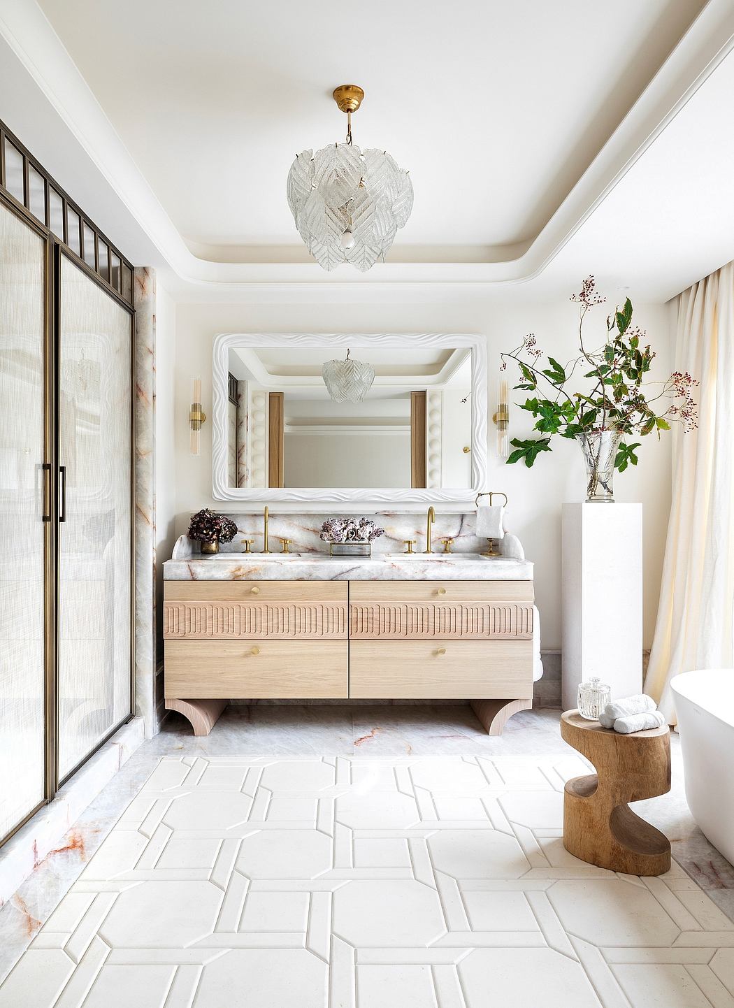 Elegant bathroom with modern marble vanity, geometric floor tiles, and ornate lighting.