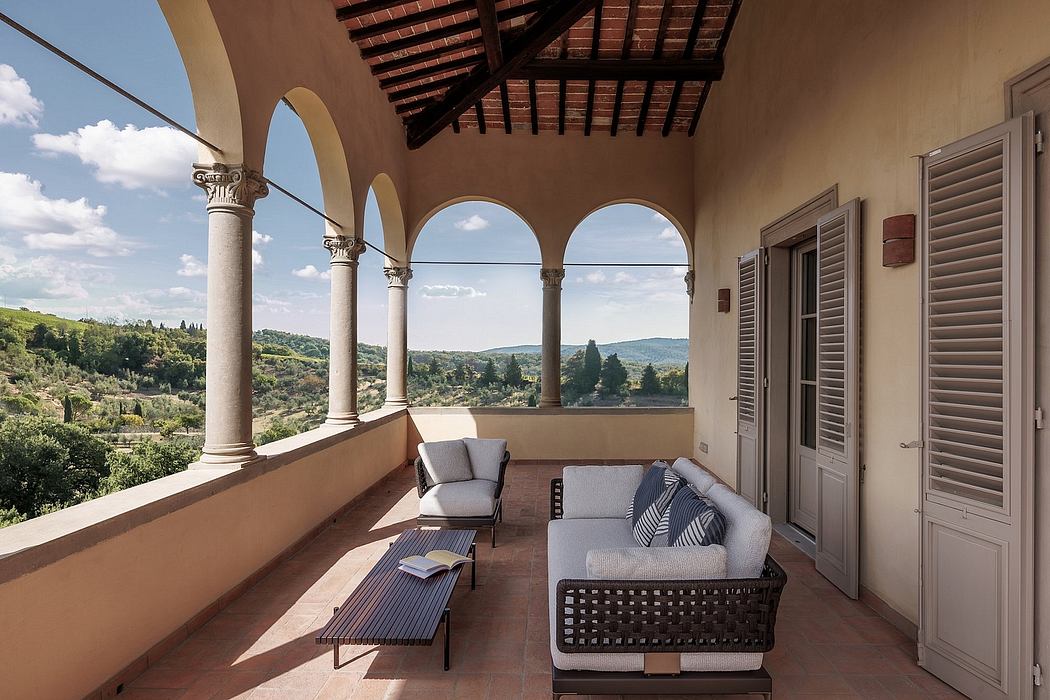 Elegant arched loggia with rustic beams and columns, offering scenic vistas.