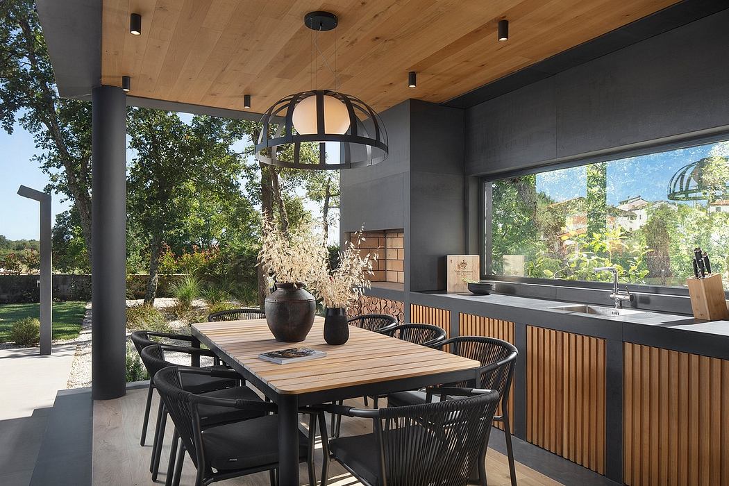 Elegant wood-paneled interior with pendant lighting, wooden table, and modern kitchen.