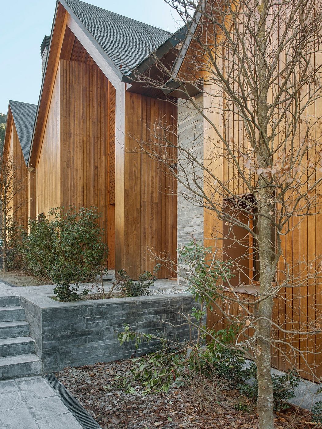 A modern wooden and stone facade with intricate architectural details.