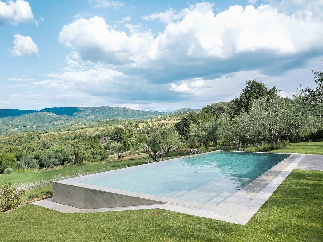 Scenic infinity pool with lush green landscape and mountains in the background.