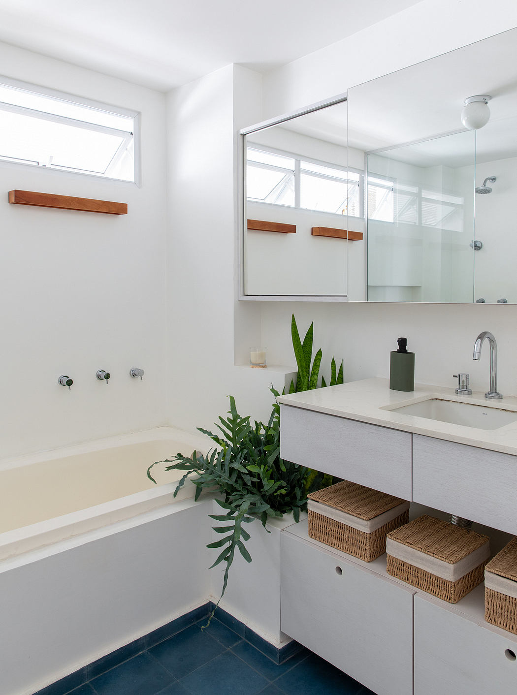 A modern, minimalist bathroom with clean lines, natural materials, and lush greenery.