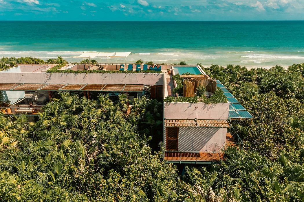 A sprawling tropical resort with a pool, cabanas, and lush greenery surrounding the buildings.