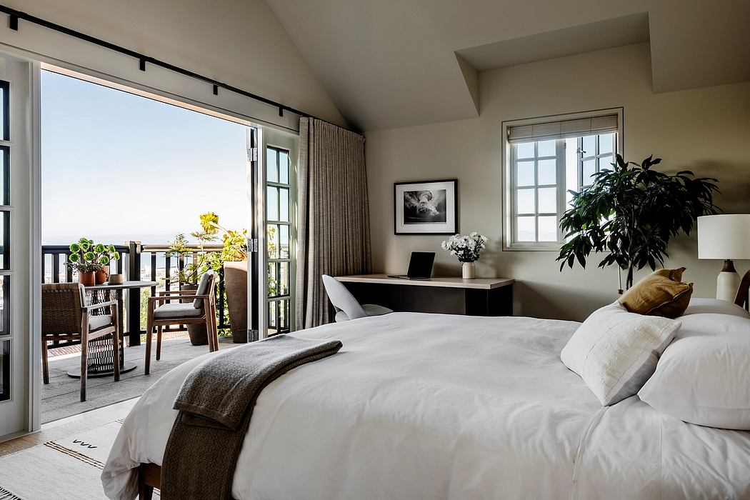 Cozy master bedroom with large windows, balcony, and modern furnishings.