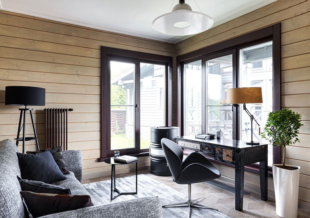 Cozy wooden-paneled room with sleek black furniture, large windows providing ample natural light.