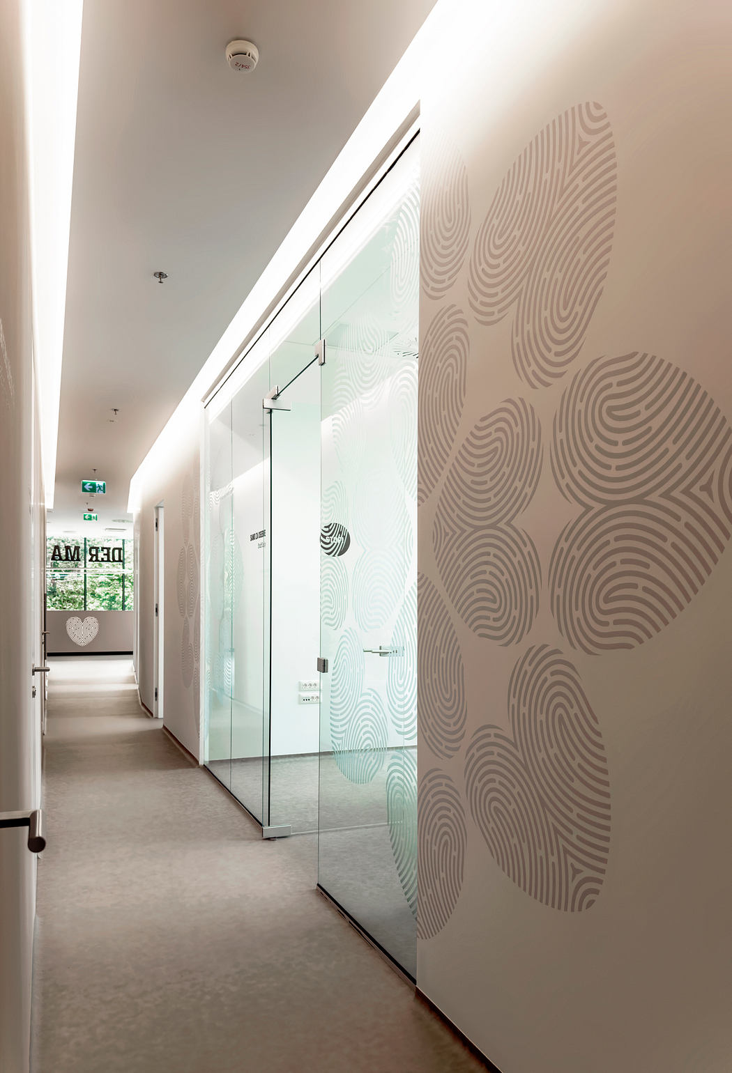 The image shows a modern hallway with a glass partition, textured wall design, and minimalist decor.