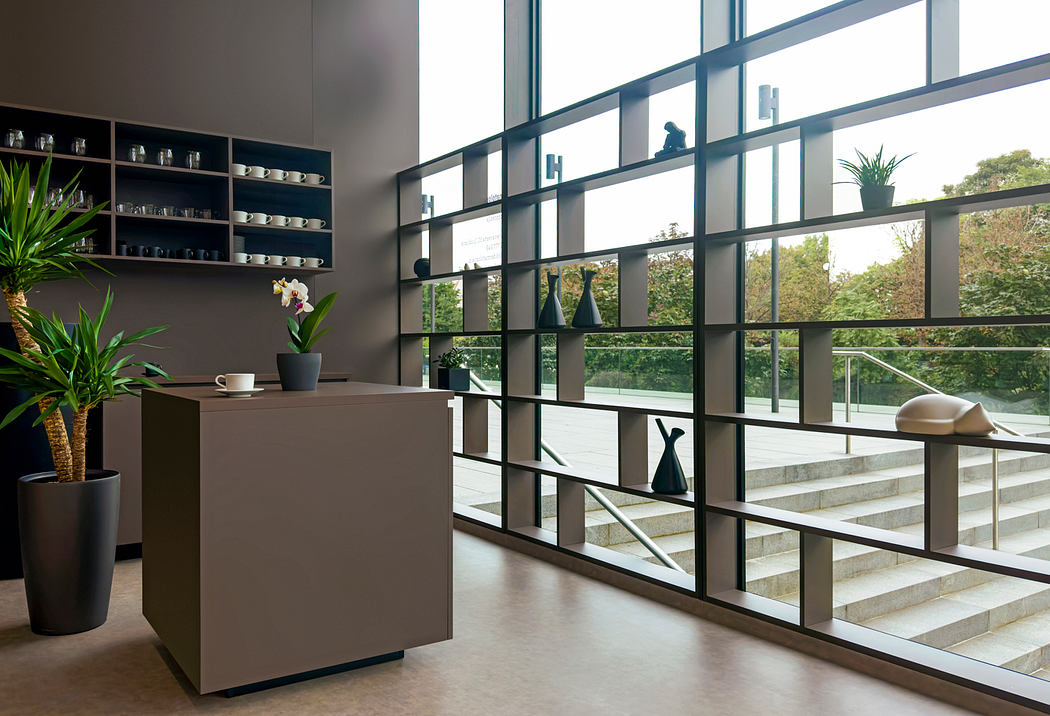 Modern interior with large windows, wood and glass shelves, and a sleek gray countertop.