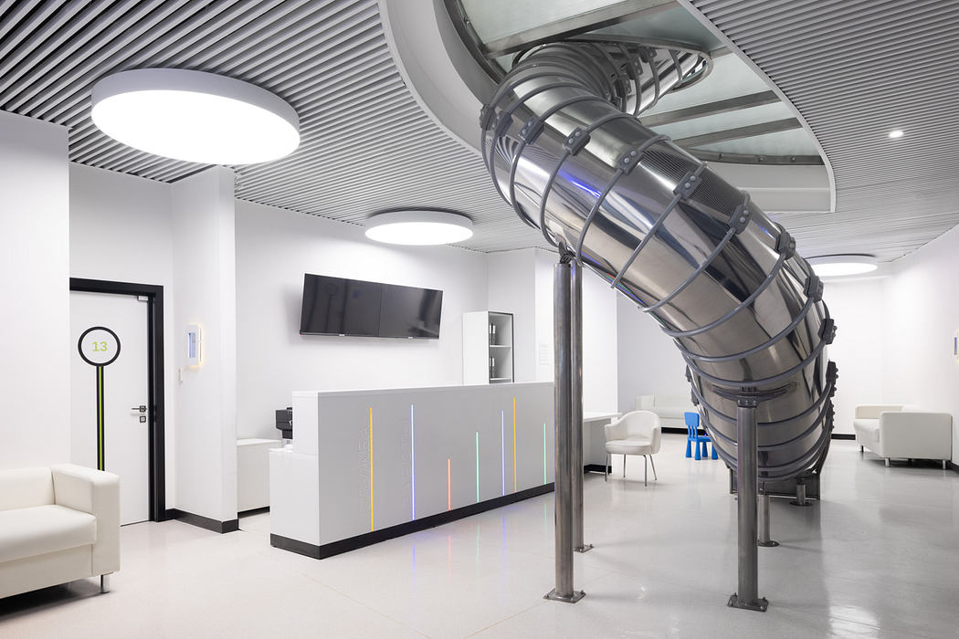 Sleek, modern office interior with spiral staircase and colorful lighting elements.