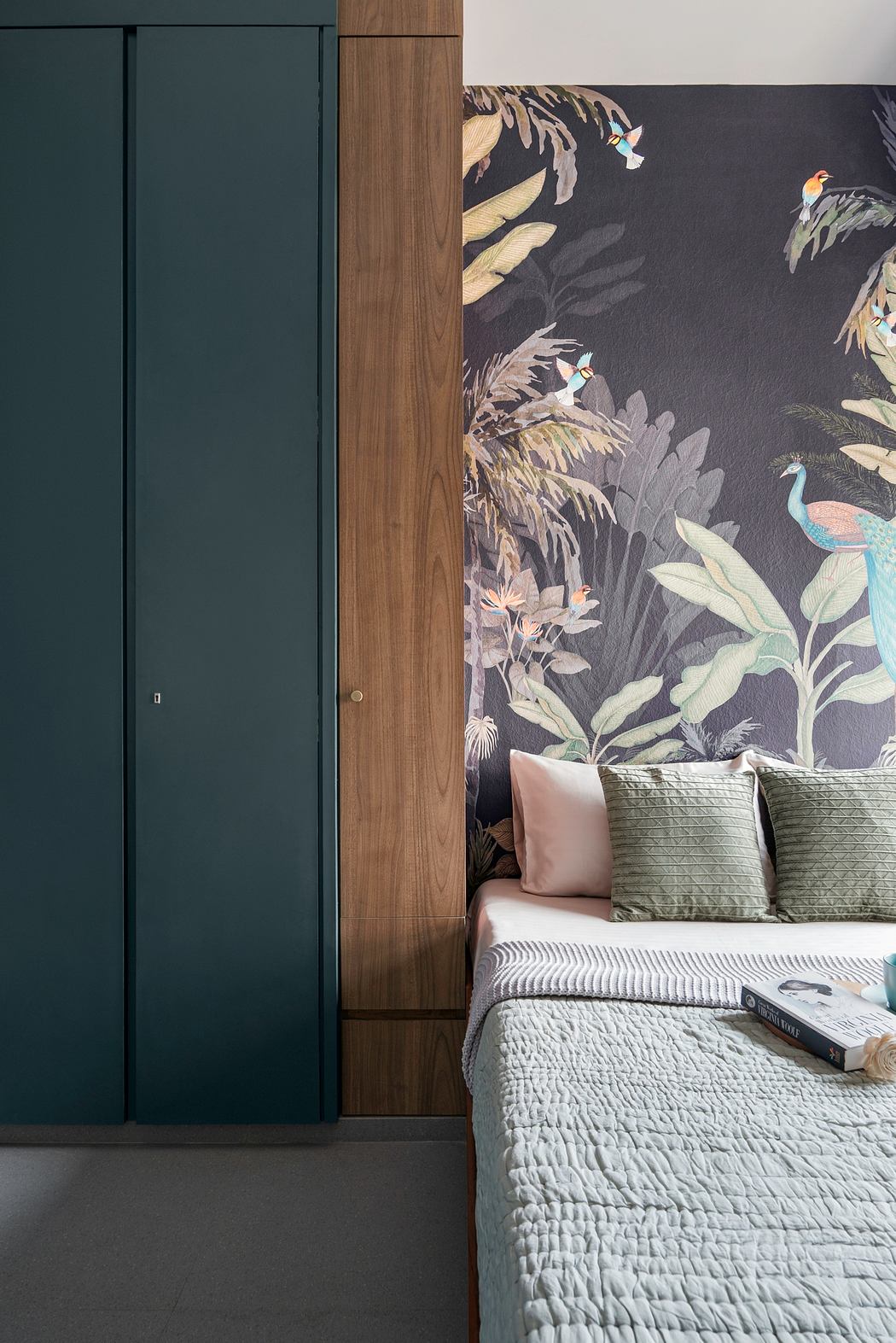 A cozy bedroom with a lush botanical wallpaper, wooden accents, and a plush bedding set.