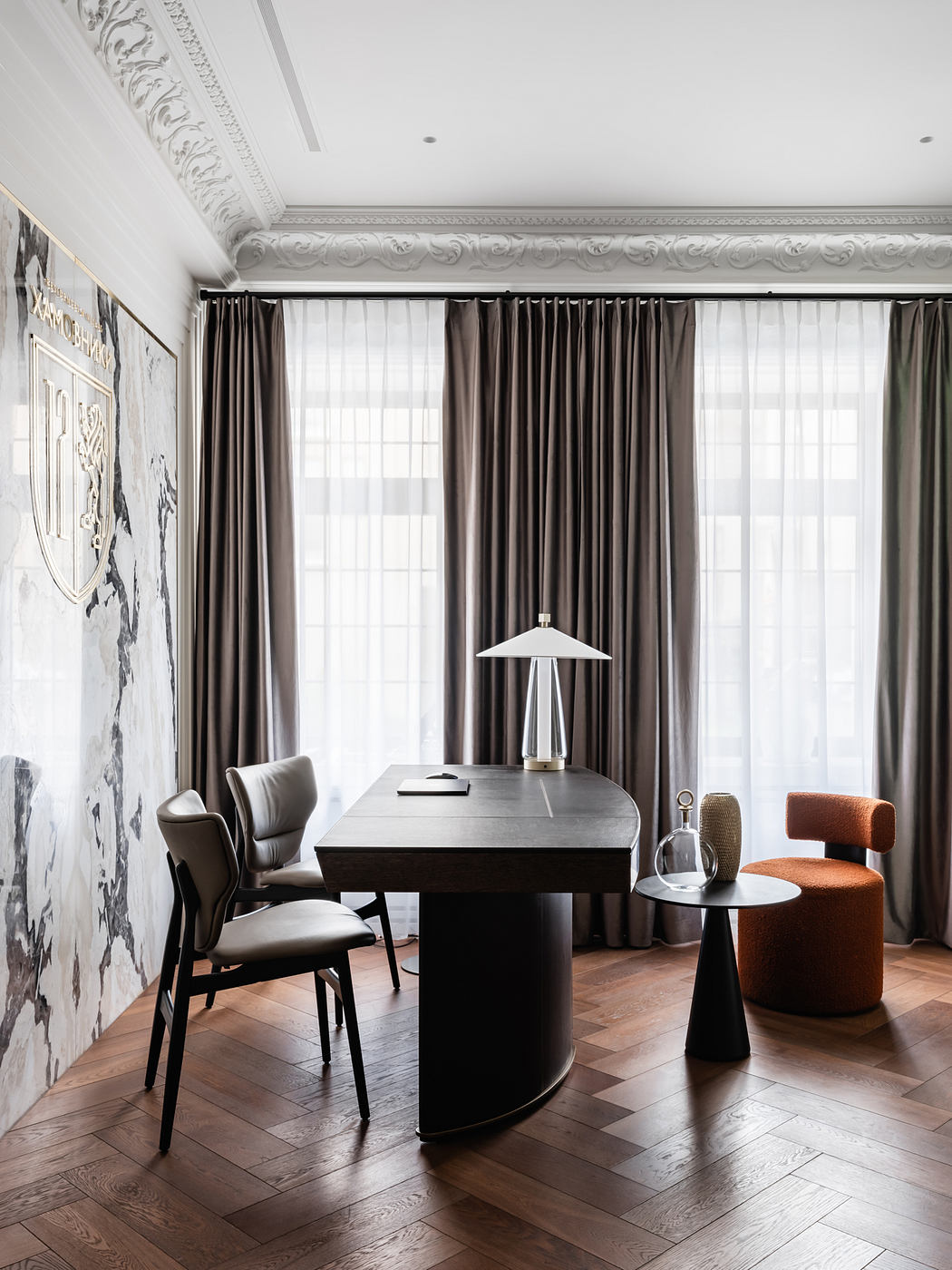 Elegant home office with ornate ceiling, patterned curtains, and modern furniture.