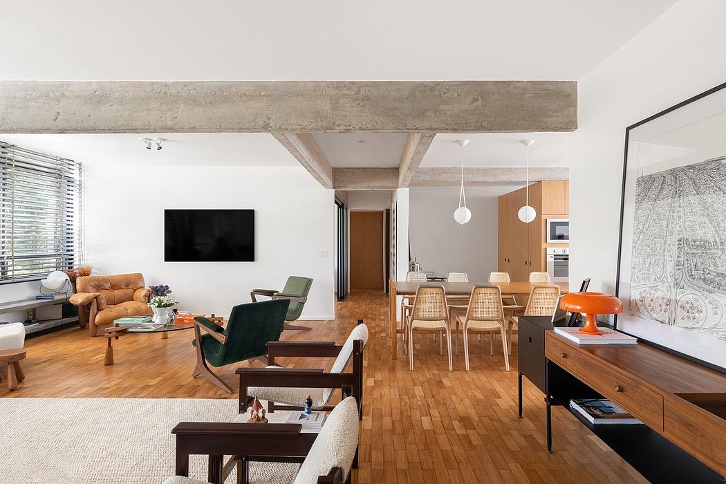 Open-concept living room and dining area with exposed concrete ceiling beams, wood floors, and modern furnishings.