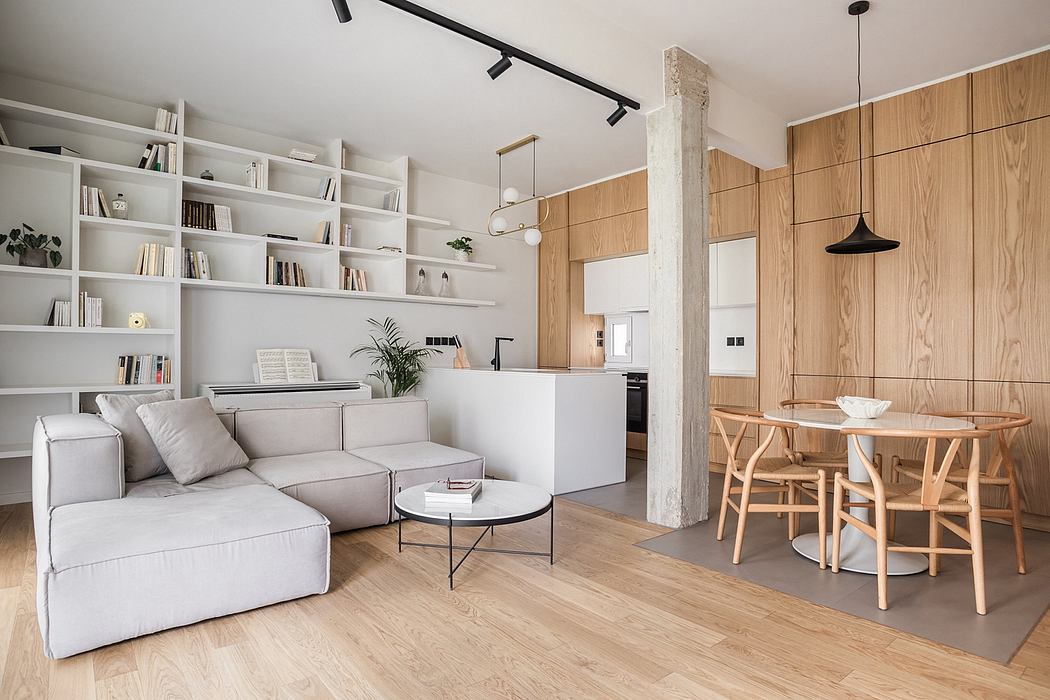 Modern, minimalist living room with wood-paneled walls, built-in shelving, and a dining area.