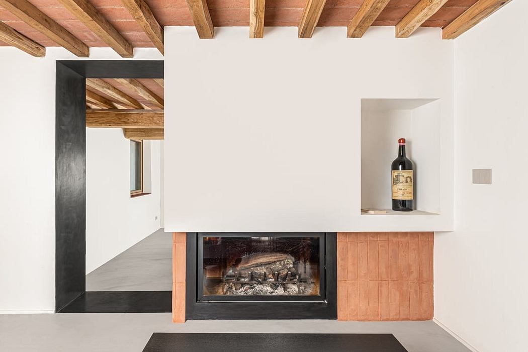 A modern minimalist room featuring a wooden ceiling, fireplace, and a bottle of wine on a shelf.