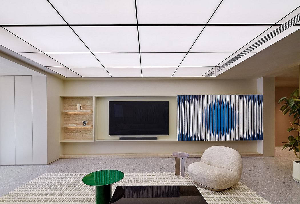 A modern open-concept workspace with a large TV, floating shelves, and geometric accents.