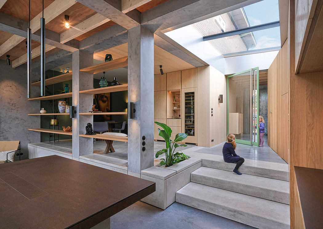 A modern, open-concept interior with natural materials, glass walls, and elevated steps.