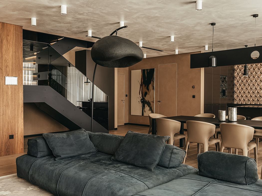 A modern, open-concept space featuring dark, moody colors, geometric lighting, and a cozy lounge area.