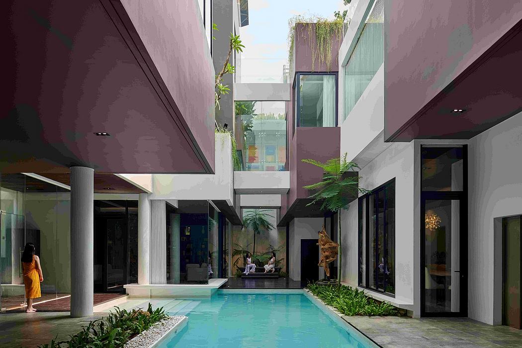 Serene courtyard with a pool, surrounded by modern architecture and lush greenery.
