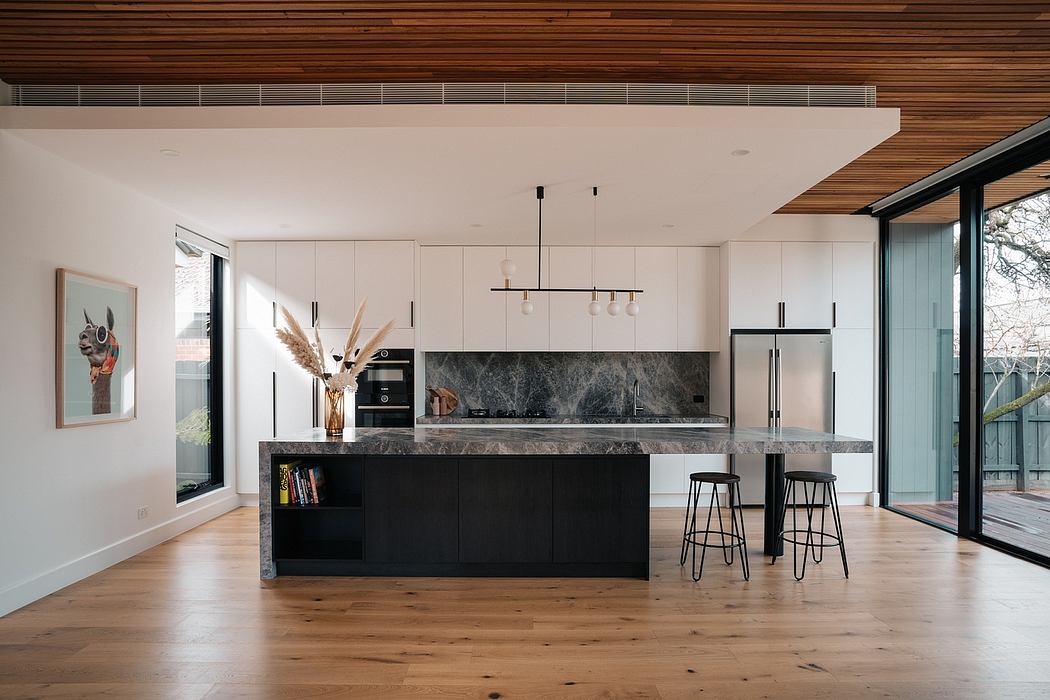 Sleek modern kitchen with contrasting white cabinetry, black marble countertop, and wood accents.