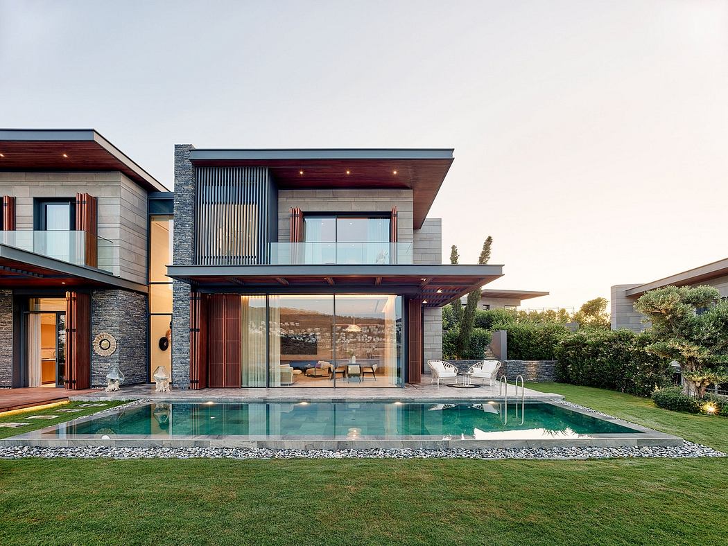 Stunning modern home with sleek lines, glass facade, and expansive pool area.