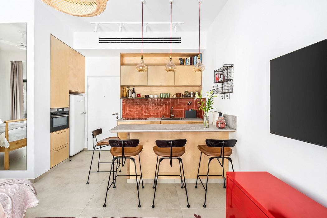 Modern kitchen with brick backsplash, wooden cabinetry, and pendant lights over a bar-style counter.
