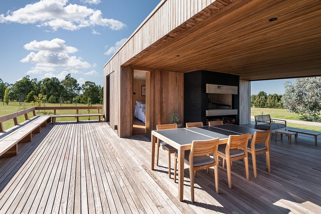 Wooden deck with dining area and expansive views of the countryside beyond.