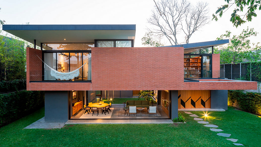 Modern two-story brick house with open-concept living spaces and outdoor patio.
