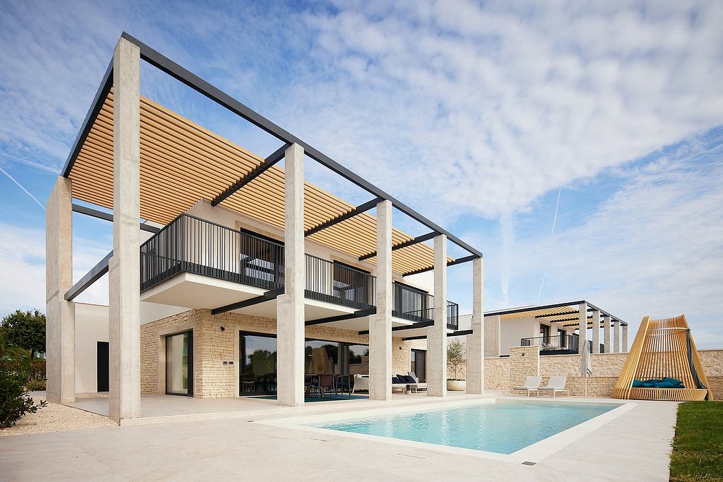 A modern, open-plan building with a stone exterior, wooden accents, and a swimming pool.