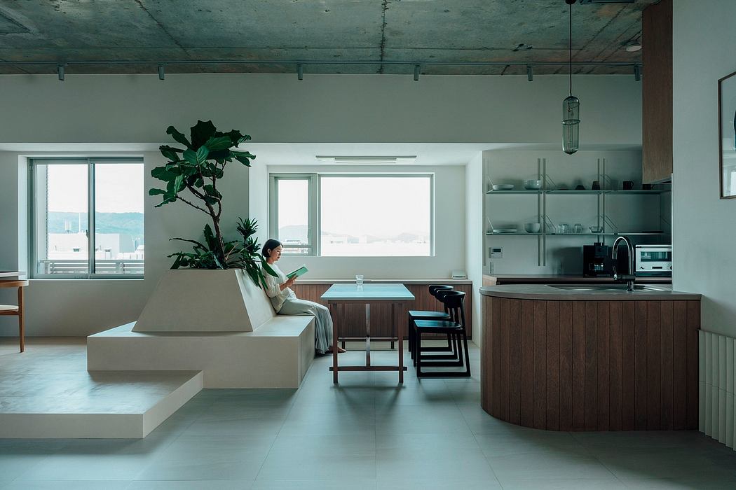 A modern, open-concept living space with a curved sofa, wood accents, and natural lighting.