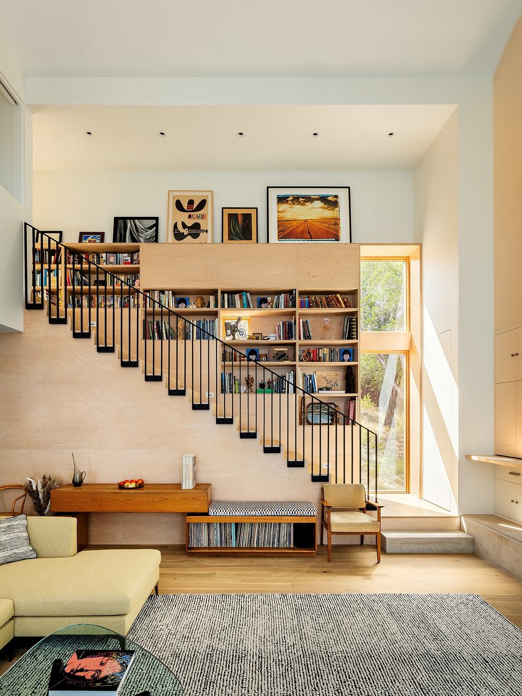Cozy living space with a creative bookshelf design, artwork, and comfortable furnishings.