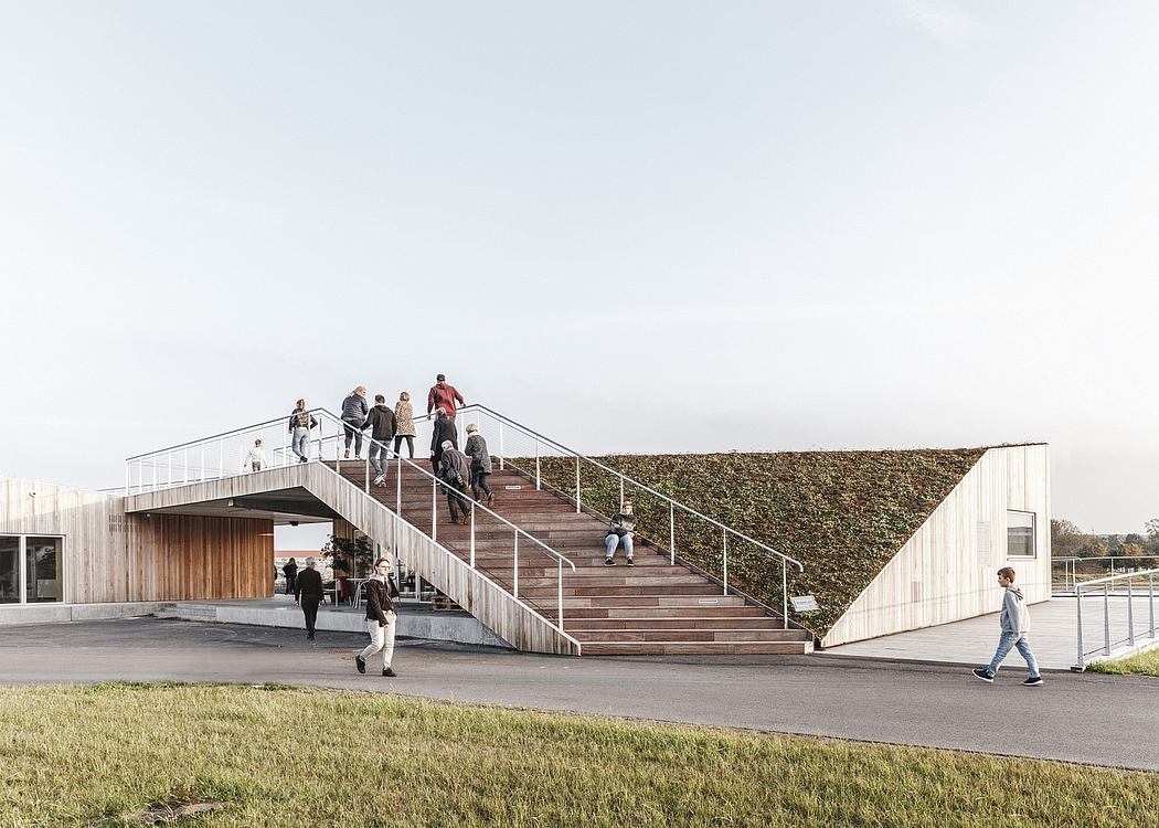 Striking architectural design featuring a prominent staircase and a verdant green wall.