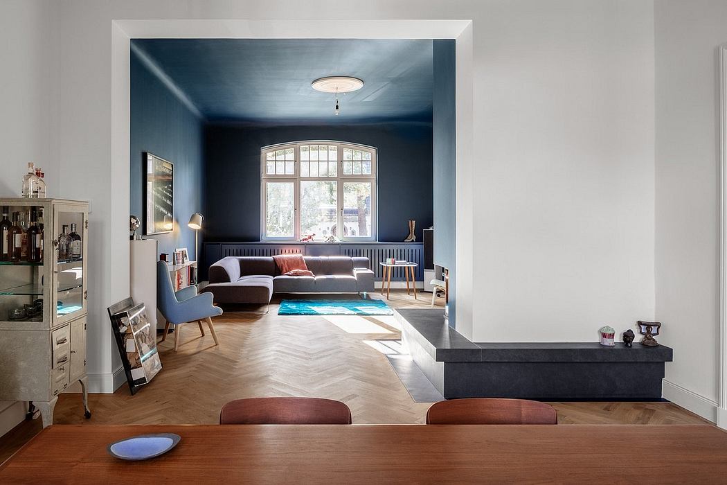 A spacious living room with high ceilings, large windows, and a stylish modern decor.