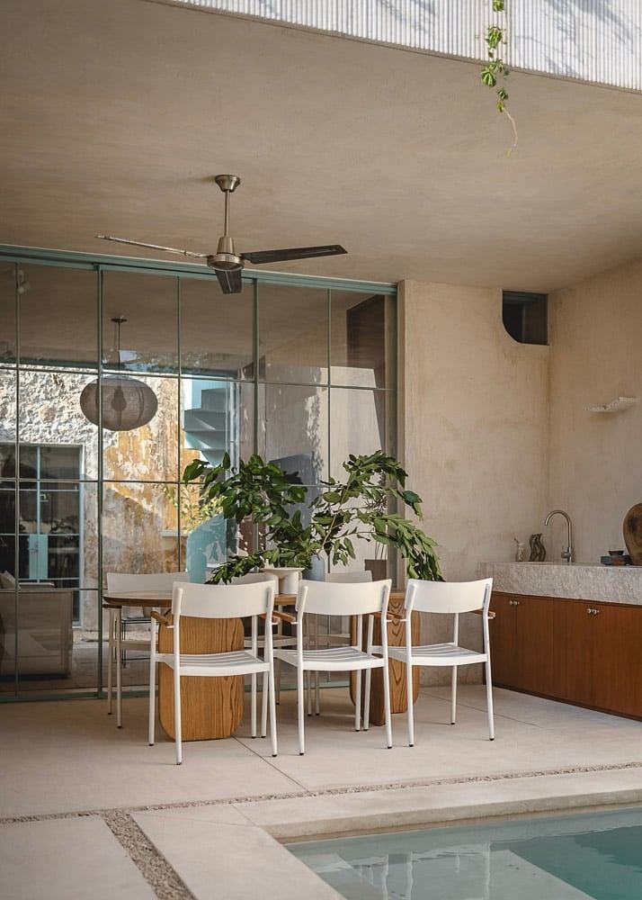 Minimalist indoor-outdoor living area with natural materials and simple furnishings.