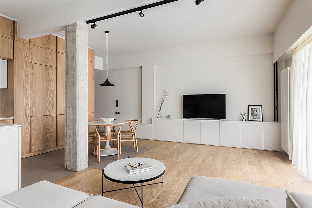 Spacious modern living area with minimalist furniture, wood accents, and track lighting.