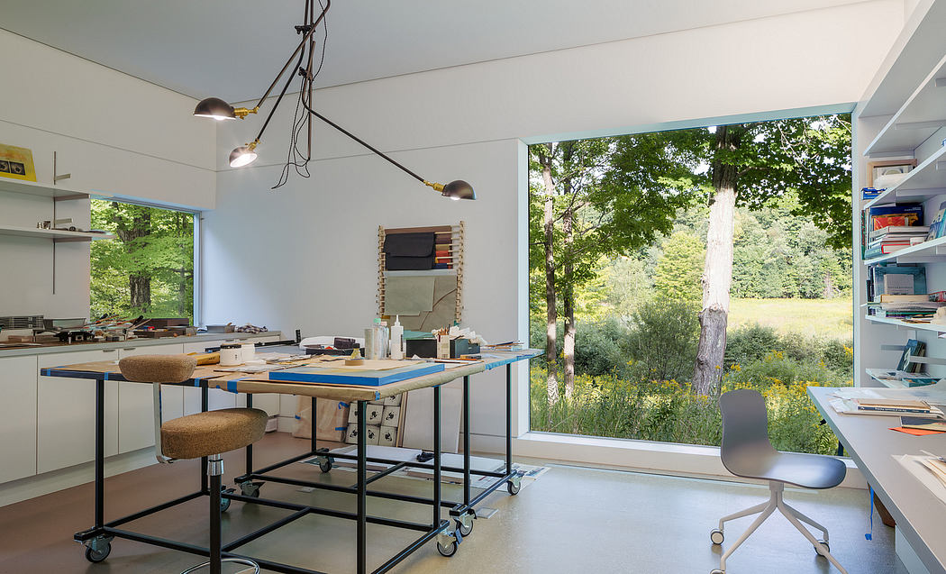 Spacious room with modern furniture, large window offering a scenic outdoor view.