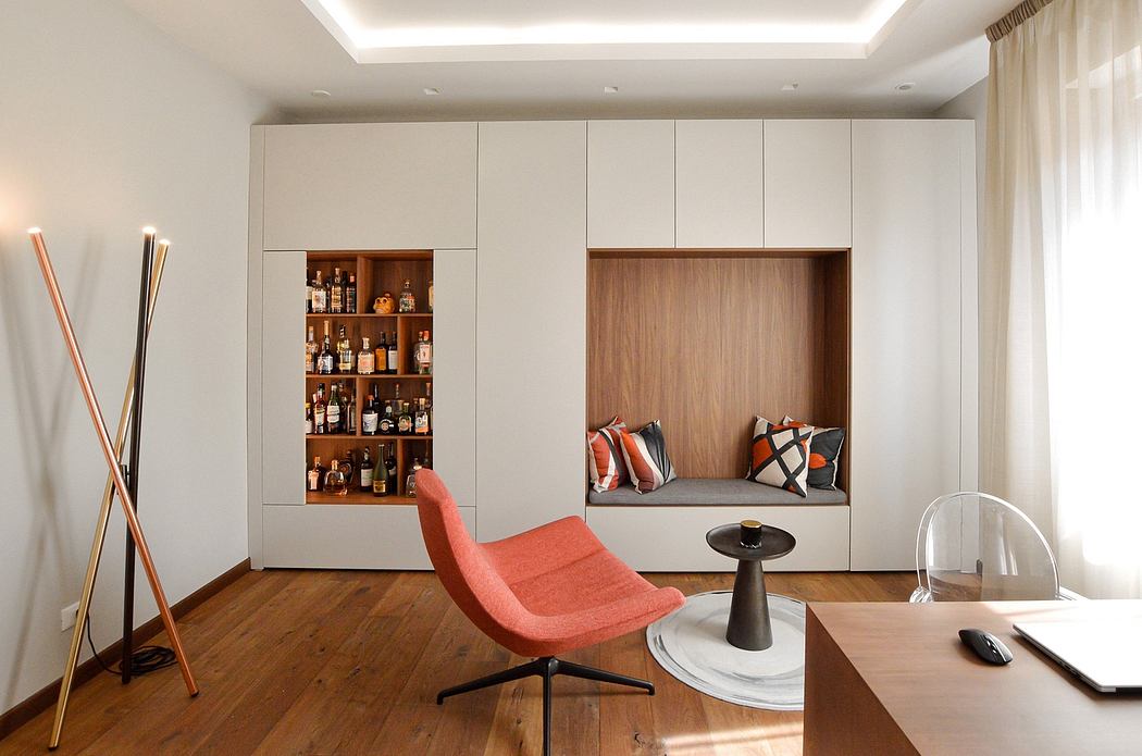 A modern interior design with built-in shelving, cozy seating nook, and minimalist decor.