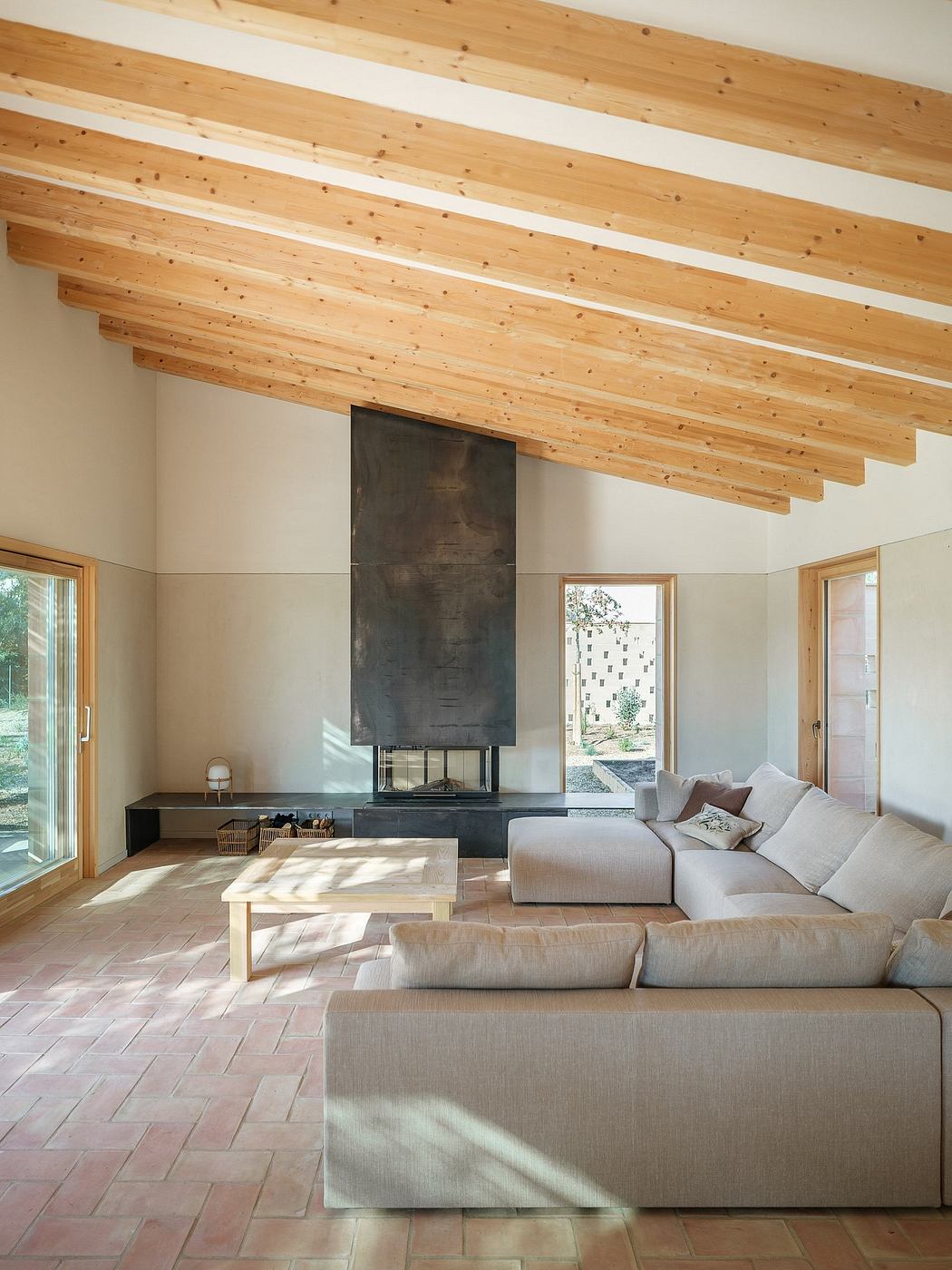 Spacious living room with wooden beamed ceiling, large fireplace, and comfortable seating.