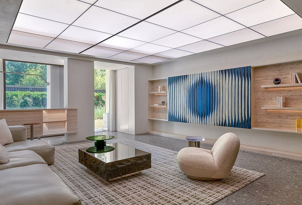 Modern living room featuring minimalist furniture, geometric artwork, and a sleek suspended ceiling.