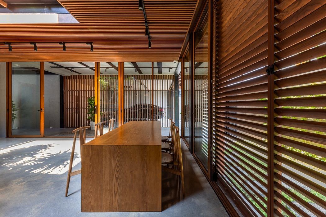 Wooden slat walls and ceiling create warm, natural ambiance in this open-concept space.
