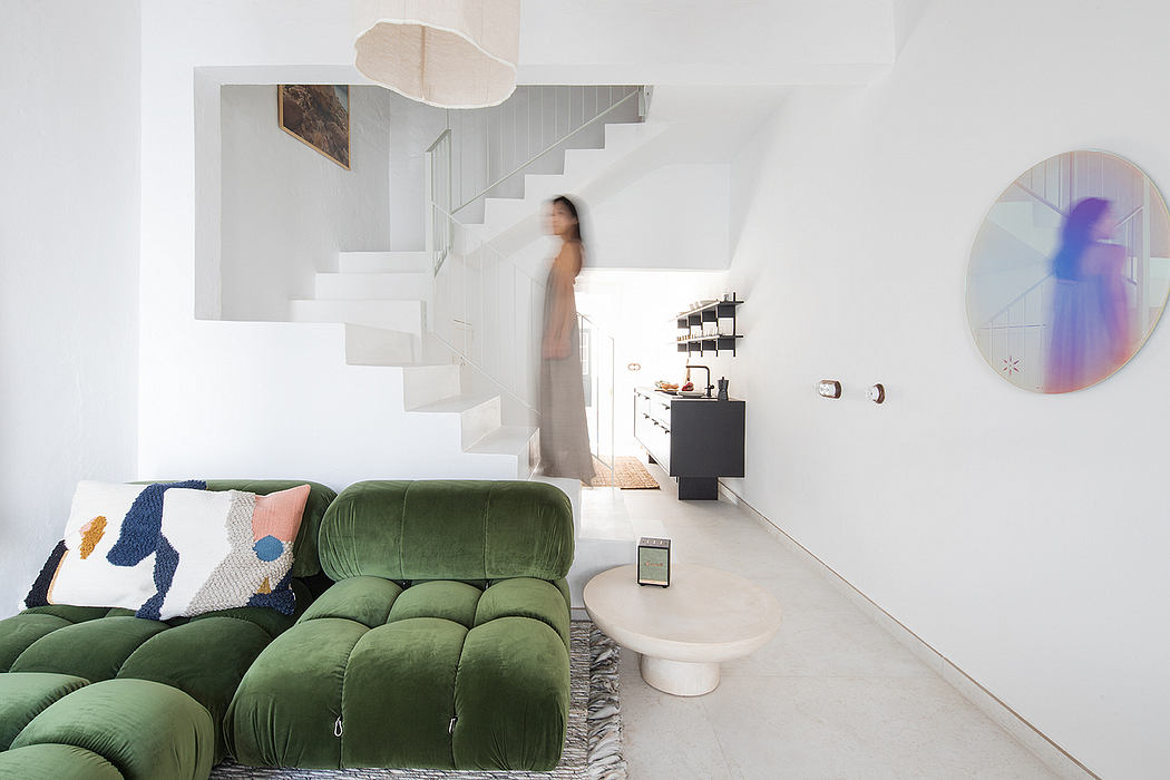 Minimalist interior with modern architecture, vibrant green sofa, and abstract artwork.