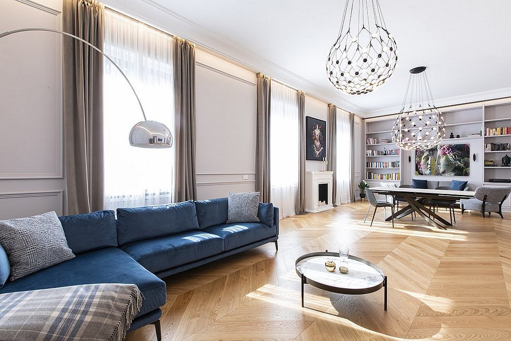 Spacious living room with elegant furnishings, chandeliers, and hardwood floors.