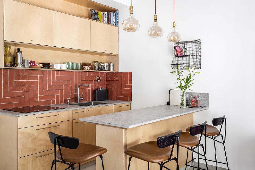 Warm-hued kitchen with modern tiles, wooden cabinetry, and pendant lighting.