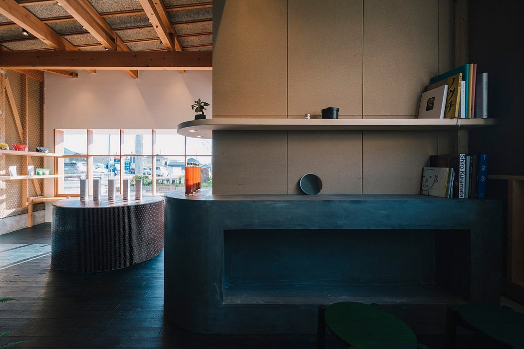 Spacious loft-like room with wooden ceiling beams, built-in shelves, and a modern, dark-toned counter.