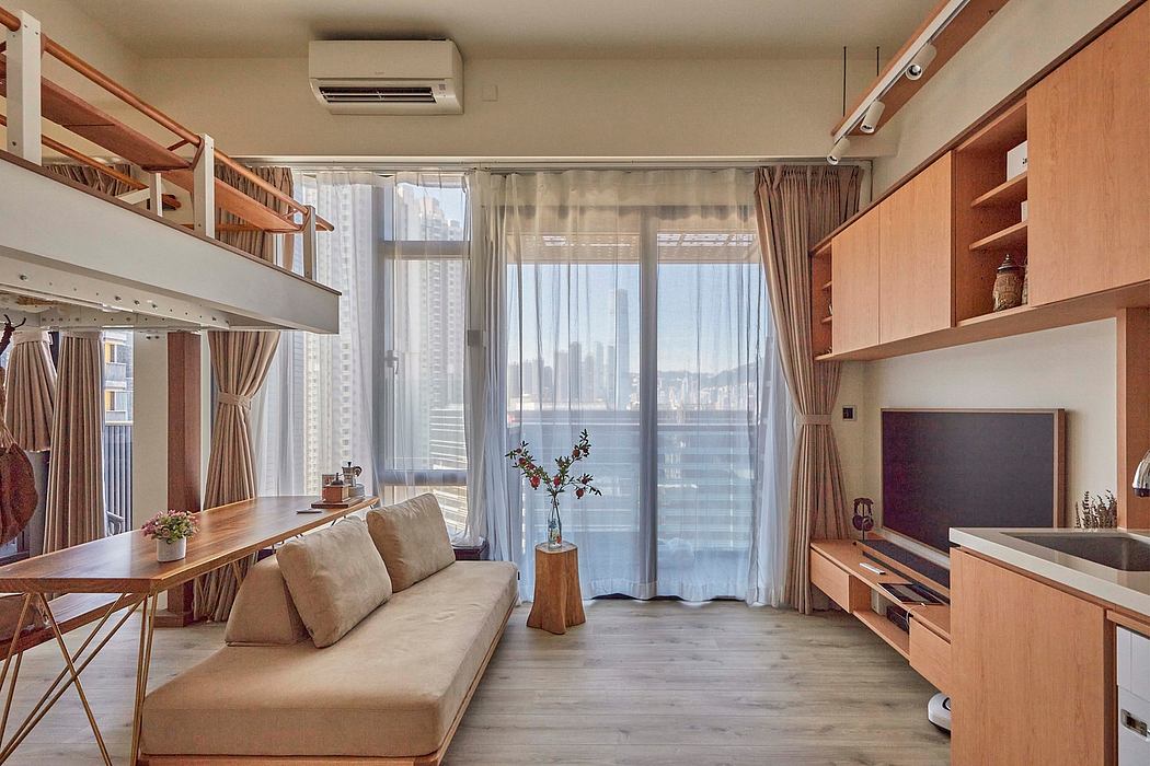 Cozy modern studio apartment with warm wood tones, large windows, and built-in shelving.