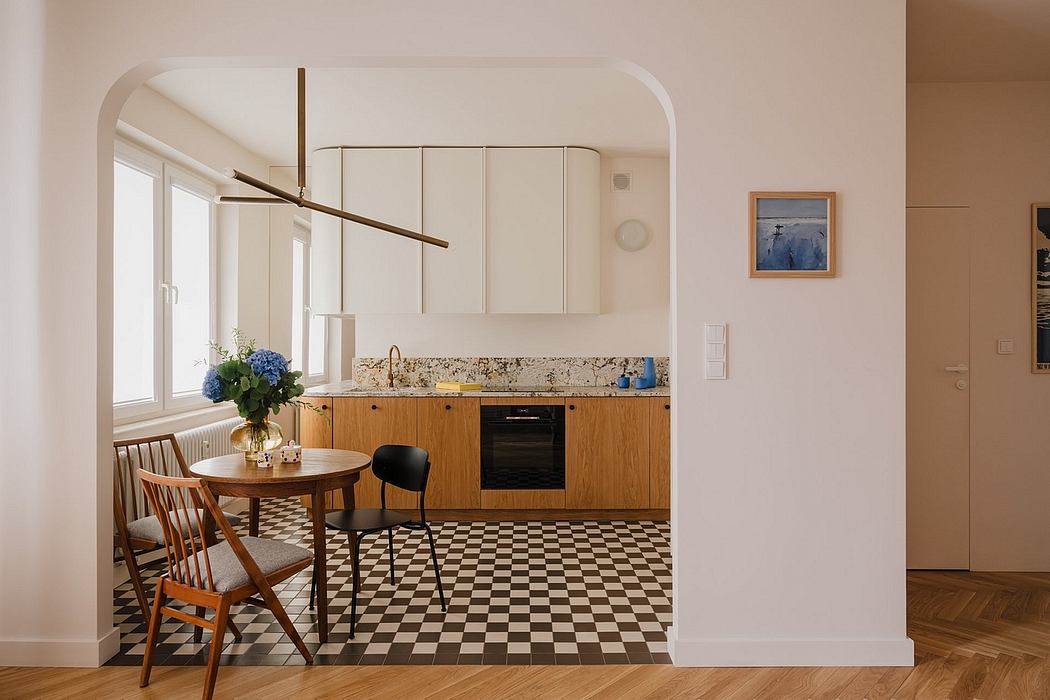 Minimalist kitchen with wooden cabinets, checkered floor, and a decorative light fixture.