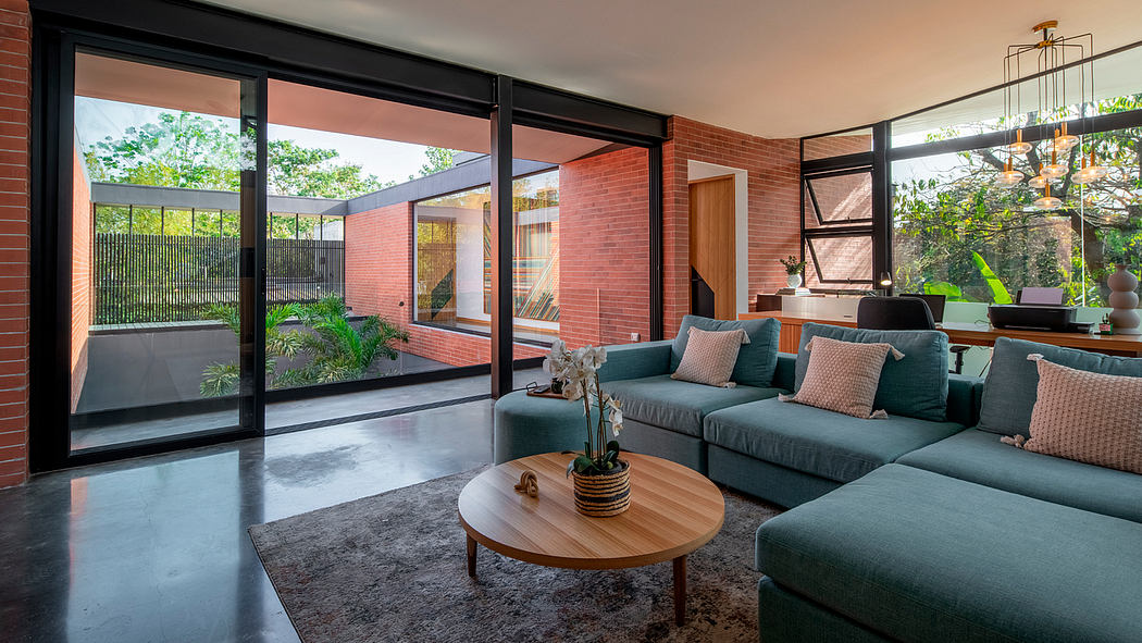 A modern living room with large windows, brick walls, and a sleek, minimalist design.