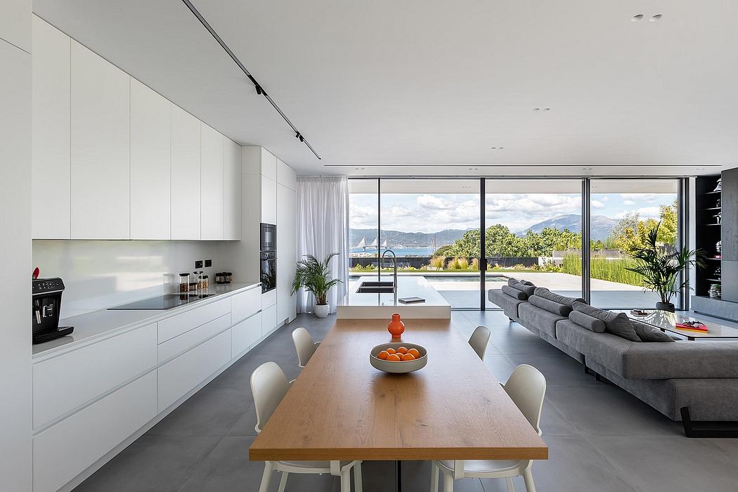 Spacious modern kitchen with open floor plan and panoramic views of the outdoors.