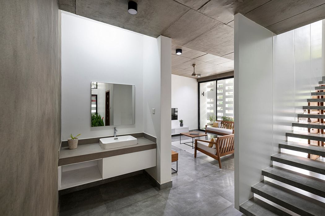 Modern minimalist bathroom with concrete walls, floating vanity, and open floor plan.
