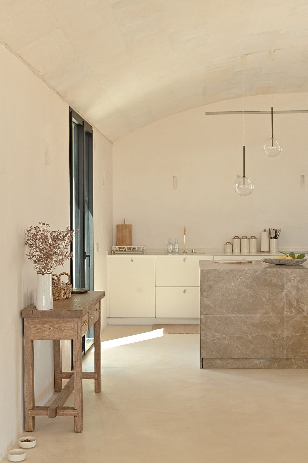 Minimalist kitchen with wooden accents, stone countertops, and pendant lighting.