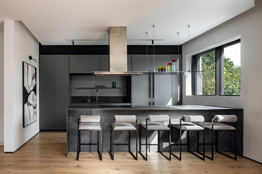 Sleek, modern kitchen with black cabinetry, stone countertops, and minimalist decor.