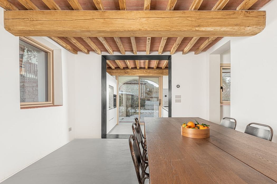 Rustic wooden beams and exposed architecture create a warm, inviting dining space.